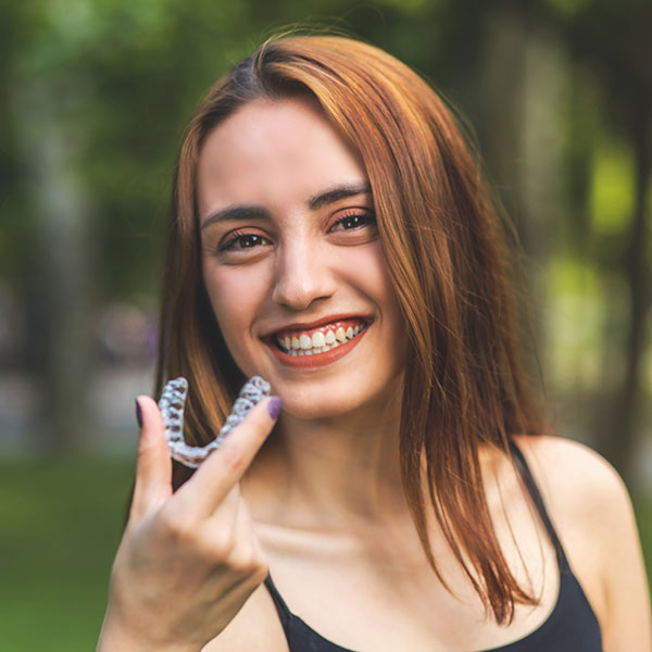 Clear Braces Young Woman Outdoors with Clear Aligners